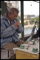 Merchant smoking.  Yuting Flower and Bird Market. Beijing.