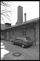 VW Golf parked next to Krematorium.  Dachau Concentration Camp.  Just outside Munich, Germany