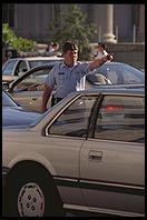 Traffic cop trying to untangle the perpetual traffic jam created in Washington, D.C. by Bill Clinton's closure of Pennsylvania Avenue to traffic by commoners.