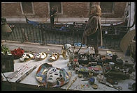 A whole pile of Venetian icons in one picture.  Foreground: carnival masks in a shop.  Middleground:  an Italian woman in wintertime should never be without a fur.  Background:  gondolier.