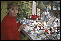 An artist painting a carnival mask