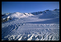 View from a helicopter flying over a glacier on the west coast of the South Island, New Zealand.