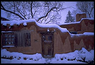 Adboe house and snow.  Santa Fe, New Mexico