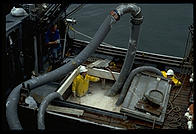 Pumping salmon out of the hold of a ship.  Petersburg Fisheries, Petersburg, Alaska.