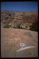 A warning sign on the Slickrock Trail as it runs along the rim of Negro Bill Canyon.  Moab, Utah.